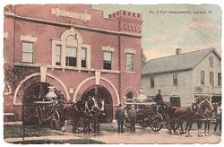 POstcard depicting fire brigade leaving fire house in carriages